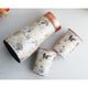 Indian Art Villa copper bottle with curved silhouette in gold floral print paired with two polished printed copper tumblers