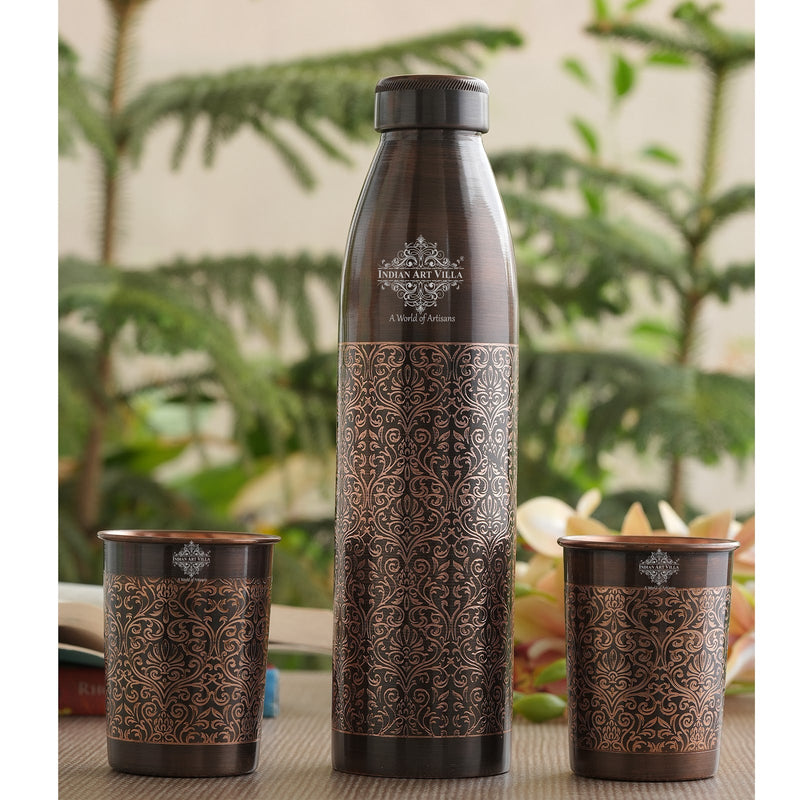 Elegant copper bottle and glasses set with embossed floral design, perfect for both decorative and functional use.