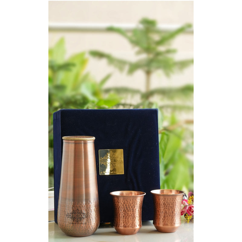 Indian Art Villa tamba bottle with two hammered copper glasses designed as a classic bedroom drinkware set for daily use