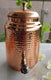 Indian Art Villa hammered pure copper water pot with stand and tap – traditional Ayurvedic water storage container for health and hydration.